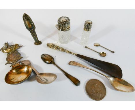 A collection of small silver ware to included two cut glass scent bottles, silver caddy spoons, teaspoons, desk seal etc 