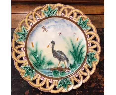 A Victorian Aesthetic period Wedgwood Majolica ceramic plate c.1870, decorated in the Japanese style with a crane by a river,
