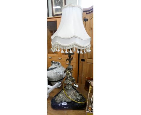 A brass Cupid figure table lamp with cream shade standing on a marble base 