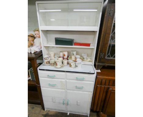 A white painted kitchen cabinet with pull out enamel table top