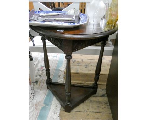 A small reproduction oak semi-circular console table with under tier 