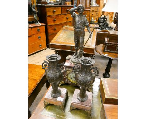 A French striking mantel clock with spelter figure mount in rouge marble and gilt metal case together with a pair of similar 