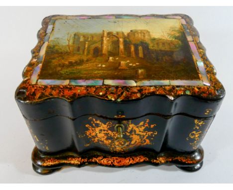 A Victorian papier mache and black lacquer tea caddy the sloped top decorated with romantic ruins scene with mother of pearl 