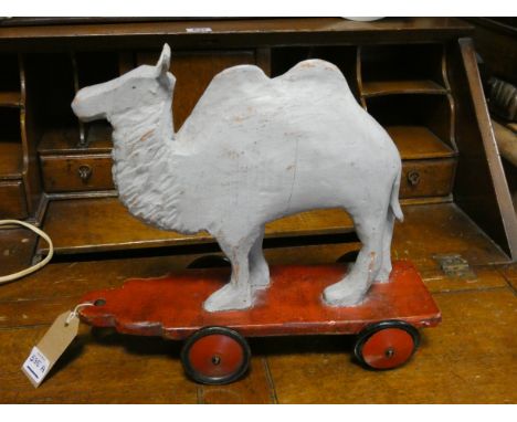 A vintage pull along wooden camel toy, circa 1940, 28 cms tall
