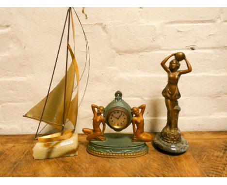An Art Deco gilt lady figure with ball standing on marble base, a small figure mounted mantel clock and a brass sailing boat 