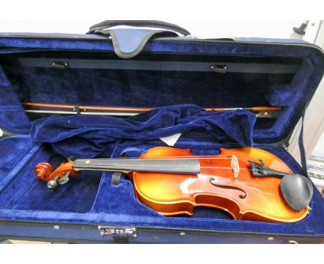 A violin in soft carrying case with bow 