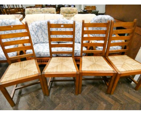 A set of four French cherry wood ladder back dining room chairs with rush seats 