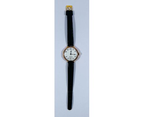 A 1930's 9ct gold trench wrist watch with white enamel dial subsidiary seconds hand, watch appears to be running at time of i