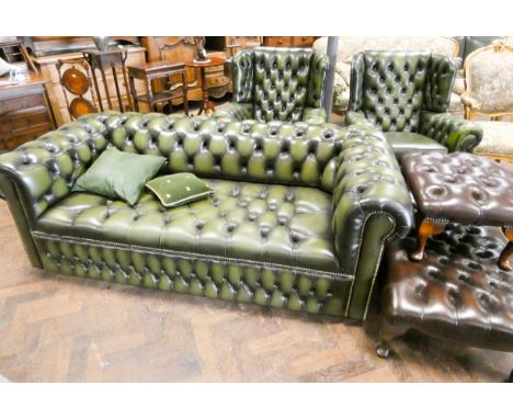 A Chesterfield three piece lounge suite in buttoned green leather, comprising of a two seater settee and two Georgian style w