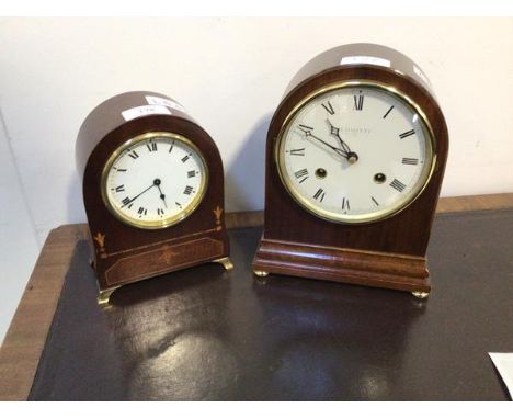 An Edwardian mahogany dome top mantel clock with sandalwood inlays, the white enamel dial with Roman chapter ring and French 