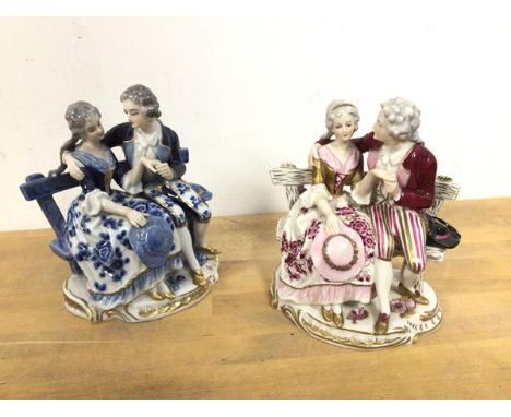 A near pair of porcelain figures, both depicting Couples on Bench, one in blues, the other in pinks, both bearing stamp to ba