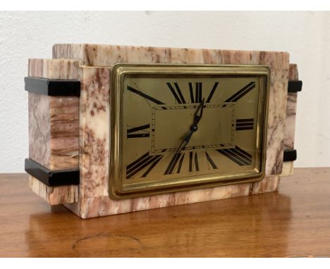 An Art Deco period rouge marble mantel clock, the dial with Roman chapter ring, eight day drum movement, manual wind with int
