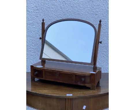 A George III and later mahogany dressing table swing mirror, the associated arched mirror with conforming string inlay, raise