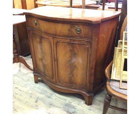 A reproduction side cabinet, the serpentine top above a frieze drawer and two cabinet doors, with single shelf to interior, o