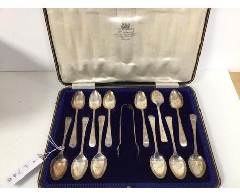 A set of twelve Sheffield silver coffee spoons, and  a pair of sugar nips, in original box inscribed R. Stewart, Argyle Stree