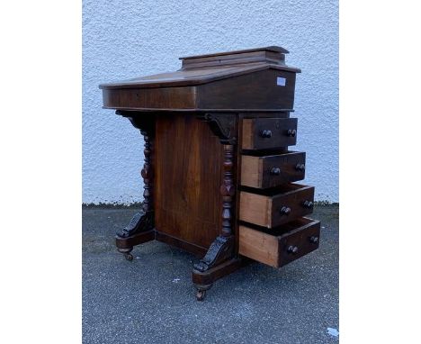 A Victorian inlaid walnut davenport, the raised hinged back revealing a plain interior, over a writing slope lifting to revea