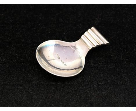 A Modernist silver caddy spoon with ridged handle and planished (hammered) reverse bowl, hallmarked by Robert Edgar Stone, Lo