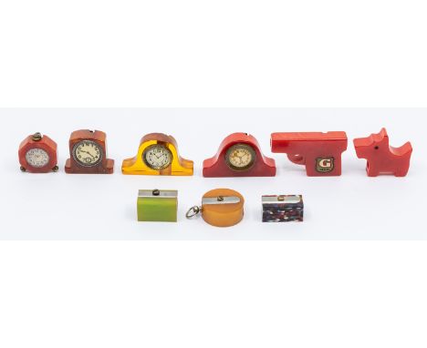 A collection of mixed 20th century novelty bakelite pencil sharpeners to include; a gun shaped version in red colourway with 