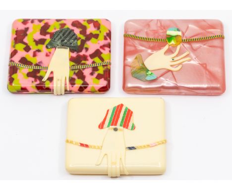 Three early to mid 20th century novelty rectangular celluloid cigarette cases, one in mottled pink, green and dark red colour