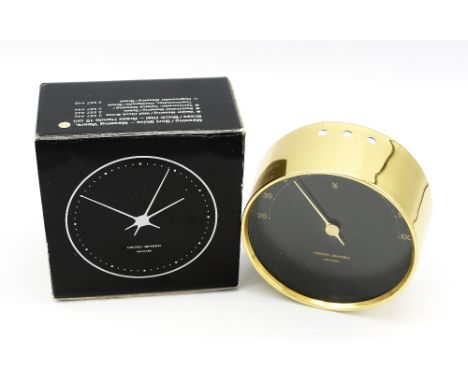 A Modern Georg Jensen boxed thermometer, having golden casing and black face with gold numbers and hand, dial marked Georg Je