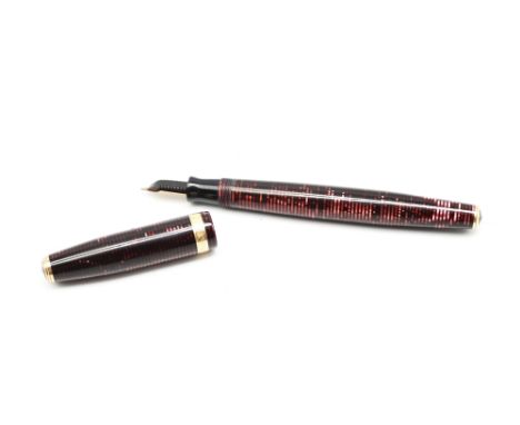 A vintage Parker Vacumatic fountain pen, with mother-of-pearl stripes to barrel and cover, the cover with gilt engraved bandi