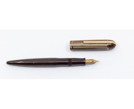 Henry Dreyfuss: a vintage Eversharp Skyline fountain pen, circa 1940s, with maroon barrel, the cover with maroon top above gr