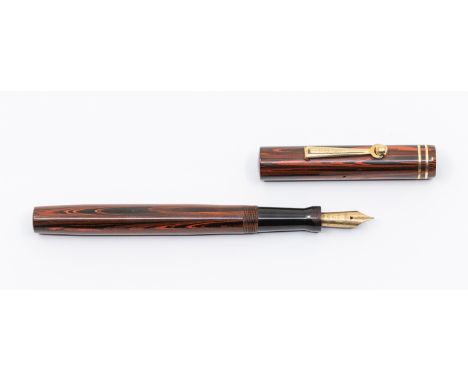 A vintage Wahl Eversharp Manifold rosewood fountain pen, the cover with gilt banding and stamped Made in USA, the clip stampe