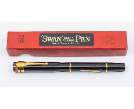 A vintage Mabie Todd & Co Swan "self filling" SF 2 lever black and gilt fountain pen, the cover with tortoiseshell terminal, 