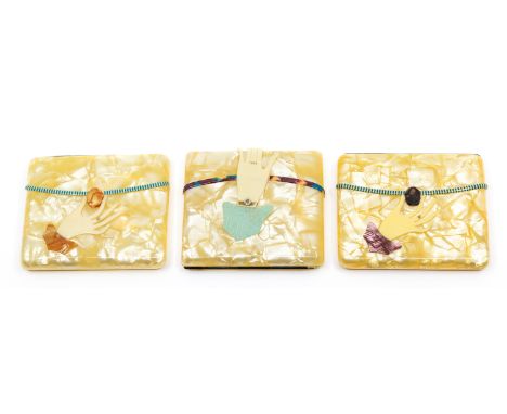 Three early to mid 20th century novelty rectangular celluloid cigarette cases, all pearlized ground design, one with wraparou