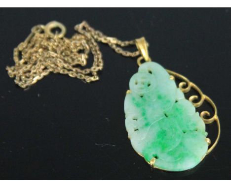 A Chinese carved celadon and green jade pendant, in yellow metal mount, 35 x 23mm, on a yellow metal neck chain stamped 14k, 