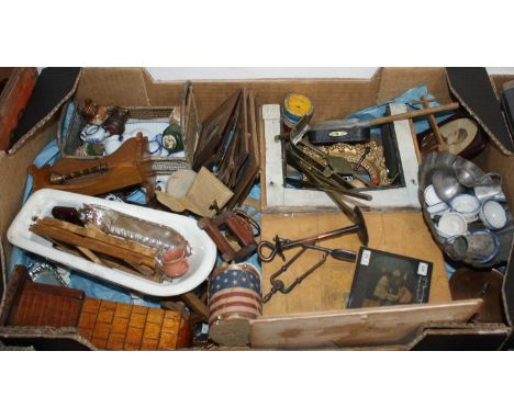 A collection of large dolls house furniture to include enamel roll top bath, fire place, and chairs