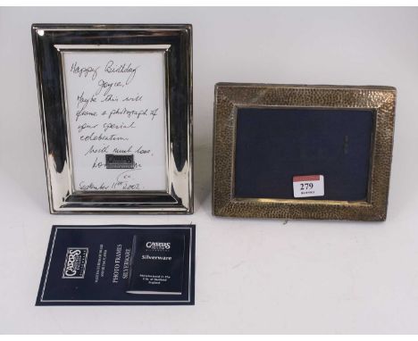 An Edwardian silver clad easel photograph frame with hammer beaten decoration, height 12cm, together with another silver clad
