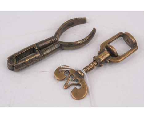 A 19th century brass thumbscrew/nut cracker, having a batwing shaped handle, max length 8cm; together with a 19th century bra