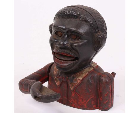 A figural novelty money-box, h.13.5cmThese items are listed on the basis they are illustrative of a bygone culture in which t