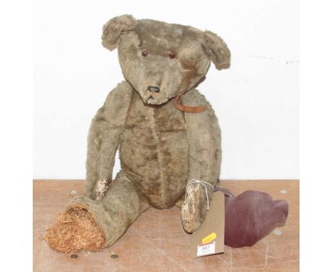 A vintage blond mohair teddy bear, having glass eyes and jointed limbsHeight approx. 50cm.Very tatty condition. 