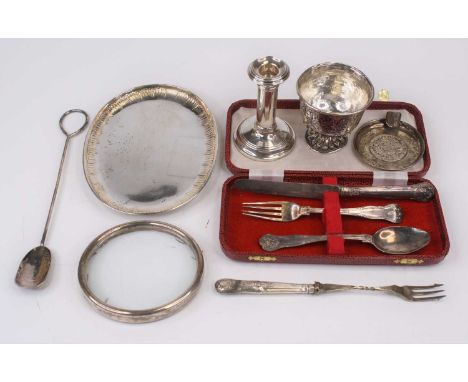 A Victorian silver christening set, comprising a knife, spoon and fork, London 1838, a weighted silver dwarf table candlestic