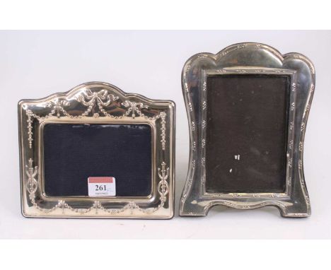 A silver-clad easel photograph frame, repousse decorated with swags and bows, h.15cm; together with another (2)