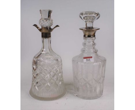 A George VI cut glass decanter, of bell shape, having a spouted silver collar, h.28cm; together with another cut glass decant