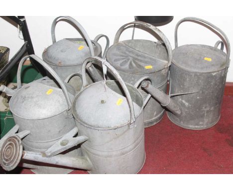 Five vintage metal watering cans, each height 45cm