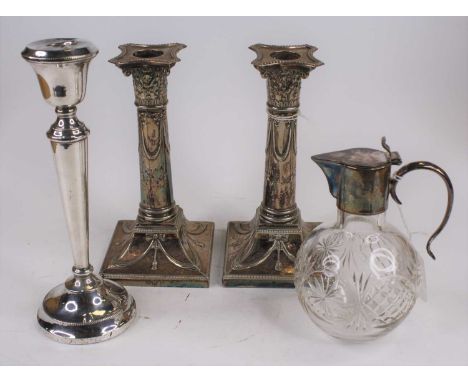 A pair of neo-classical style silver plated table candlesticks, each having a corinthian capital above a cylindrical column d