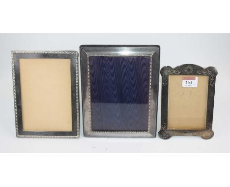 A silver-clad easel photograph frame, of rectangular shape, h.21cm; together with another silver example; and a further plate