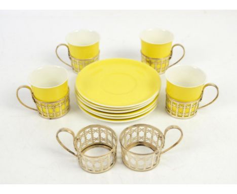 Four Shelley China yellow coffee cups and six saucers and six silver cup holders, Condition Report:  The holders are hallmark