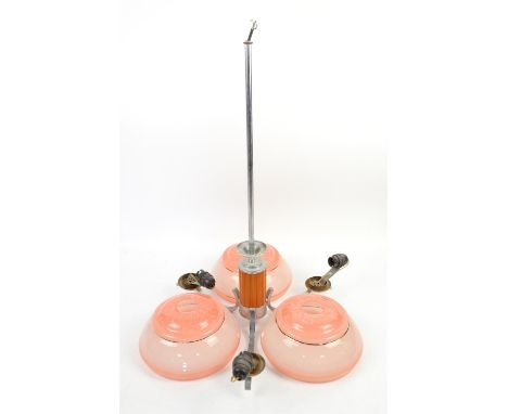 Art Deco three branch chrome ceiling light with three blush pink glass shades, caramel bakelite column