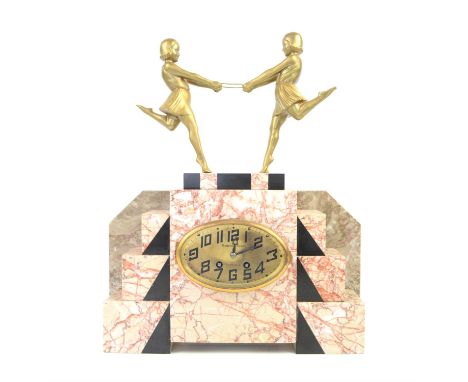 Art Deco clock mounted with a pair of gilt female figures holding a hoop, on stepped pink with black marble, inscribed Bernar