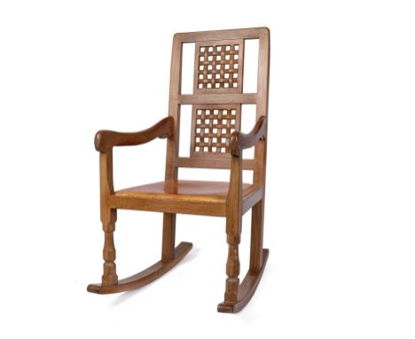 Robert 'Mouseman' Thompson of Kilburn, oak rocking chair with a double lattice back and tan leather studded seat, h98cm. Prov