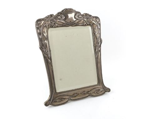 An Art Nouveau silver dressing table mirror by E Mander & Son, Birmingham 1902 with bevelled mirror plate, strut back. Mirror