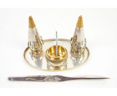 Silver and gilt cruet set comprising salt, pepper h10cm, and mustard pot with spoon, in the manner of Stuart Devlin, on oval 