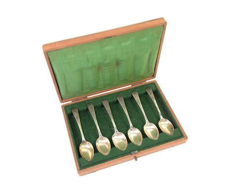Liberty set of six silver teaspoons, hallmarked, in wooden case lined with green silk which is stamped 'Liberty London-Paris 