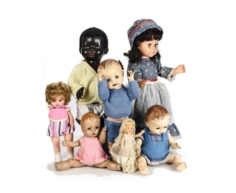A black Pedigree hard plastic Walking Doll, with knitted cardigan and boots, cracked hand and light scratches to the face and