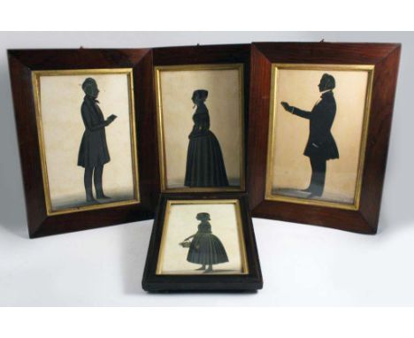 J. SKEOLAN:-  Silhouette portrait of a man standing holding a book, signed & dated 1854; 26 x 27 cms, another similar, a port